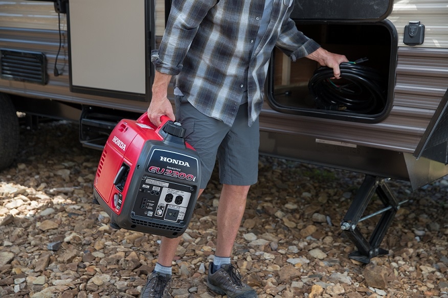 man carrying portable rv generator